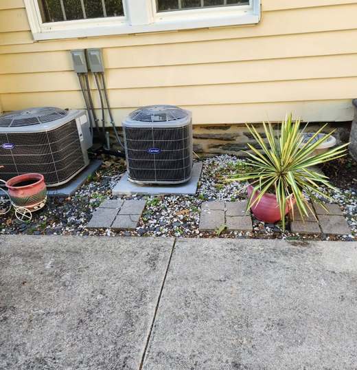 Before: two air-conditioning condensers beside a house on loose gravel and scattered pavers, next to a cracked concrete walk.